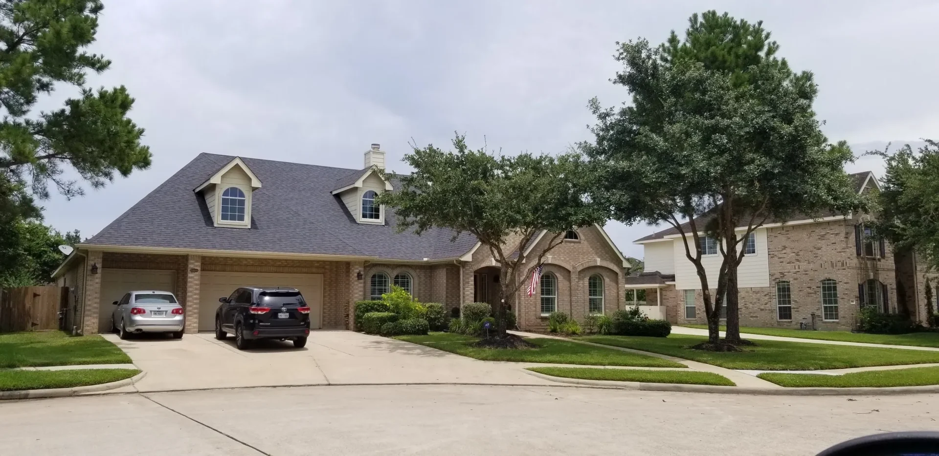 Two-story brick home with attached garage.