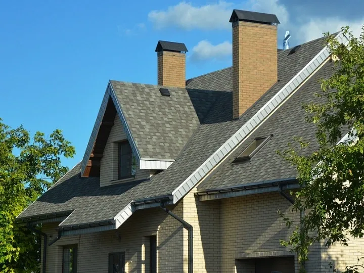 A house with two chimneys and a roof.