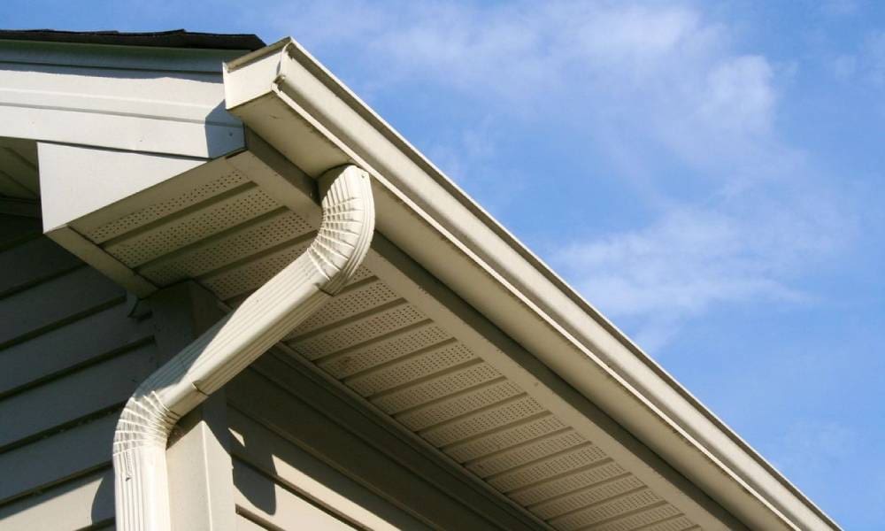 A rain gutter on the corner of a house.