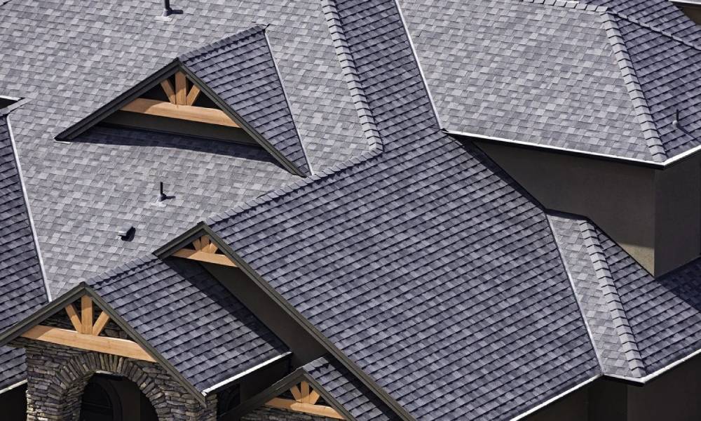 An aerial view of a house with gray shingles.